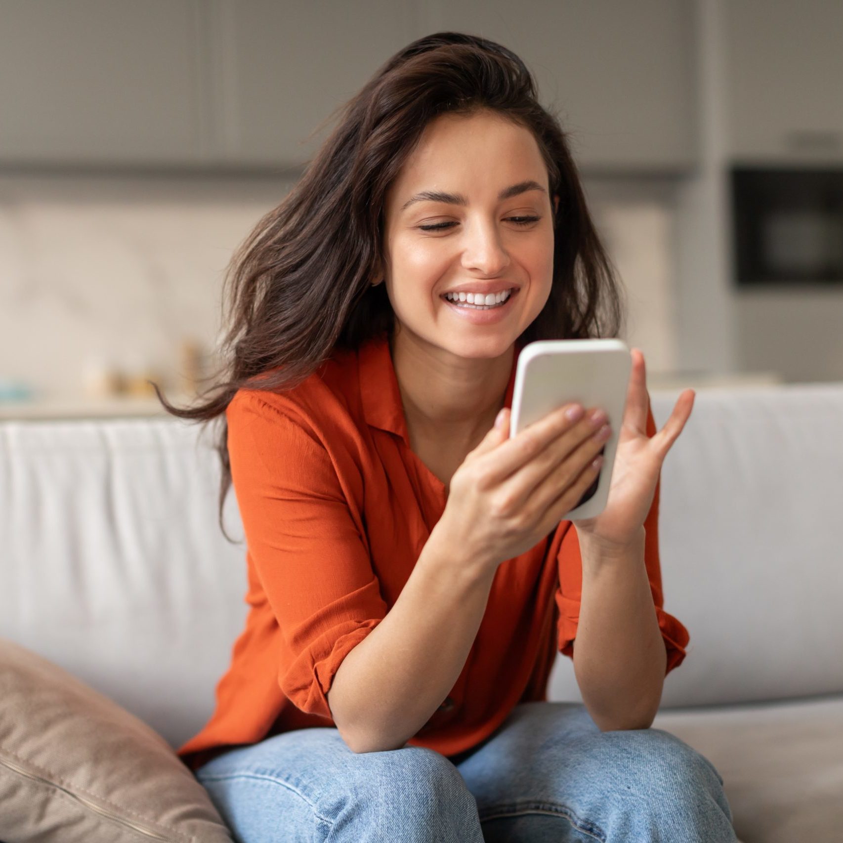 Happy woman using the Jetdates app.